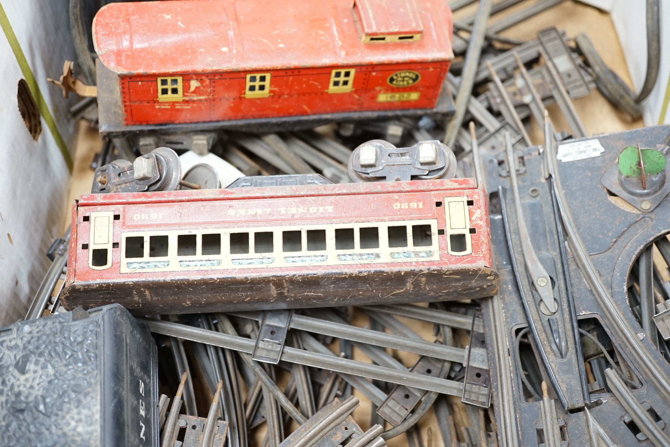 Lionel Lines gauge O tinplate American outline model railway, including seven items of rolling stock together with a quantity of three rail track sections